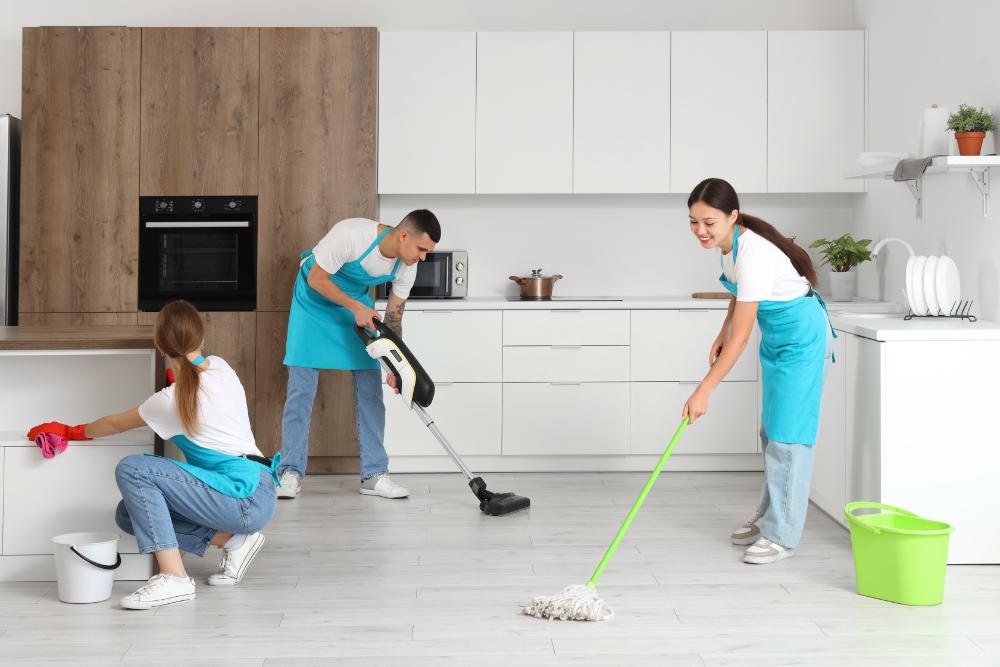 People cleaning a kitchen together